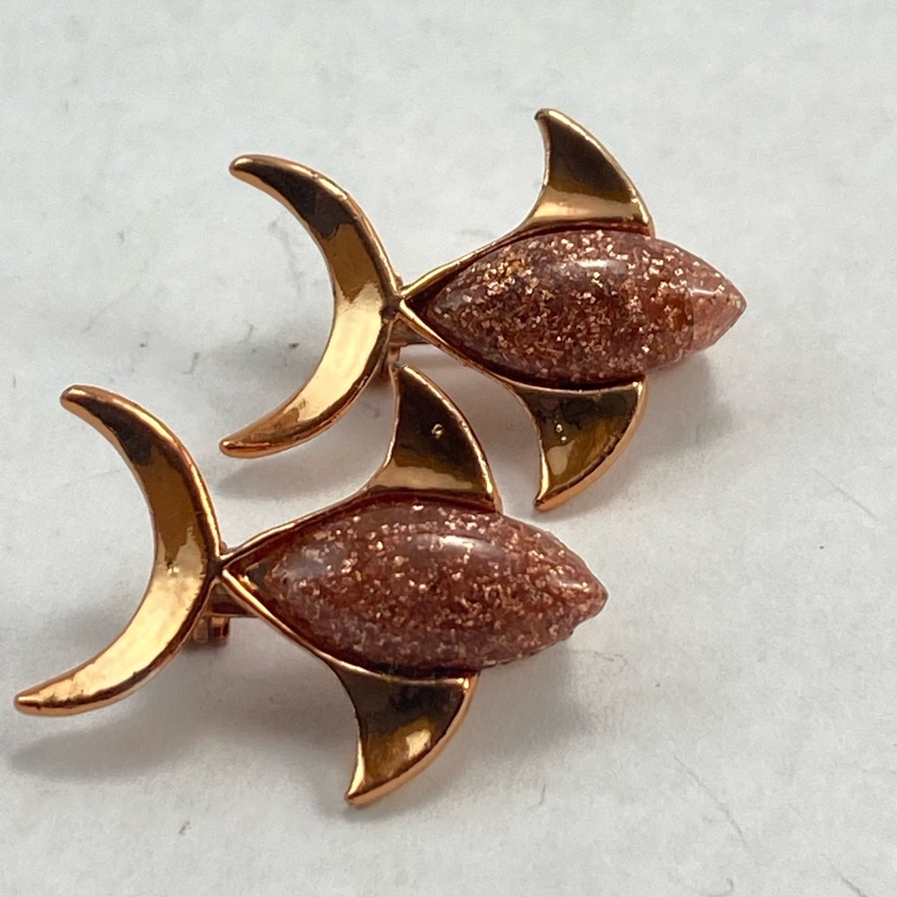 Two vintage gold small fish brooches.